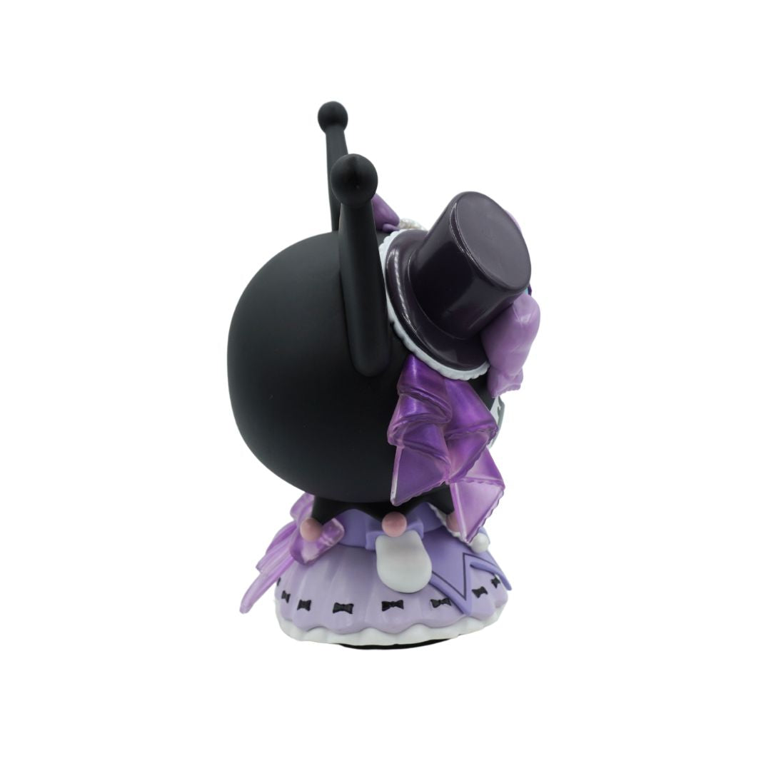 A small black teapot figurine with a purple ruffled dress and a black top hat, shown from the back on a plain white background.