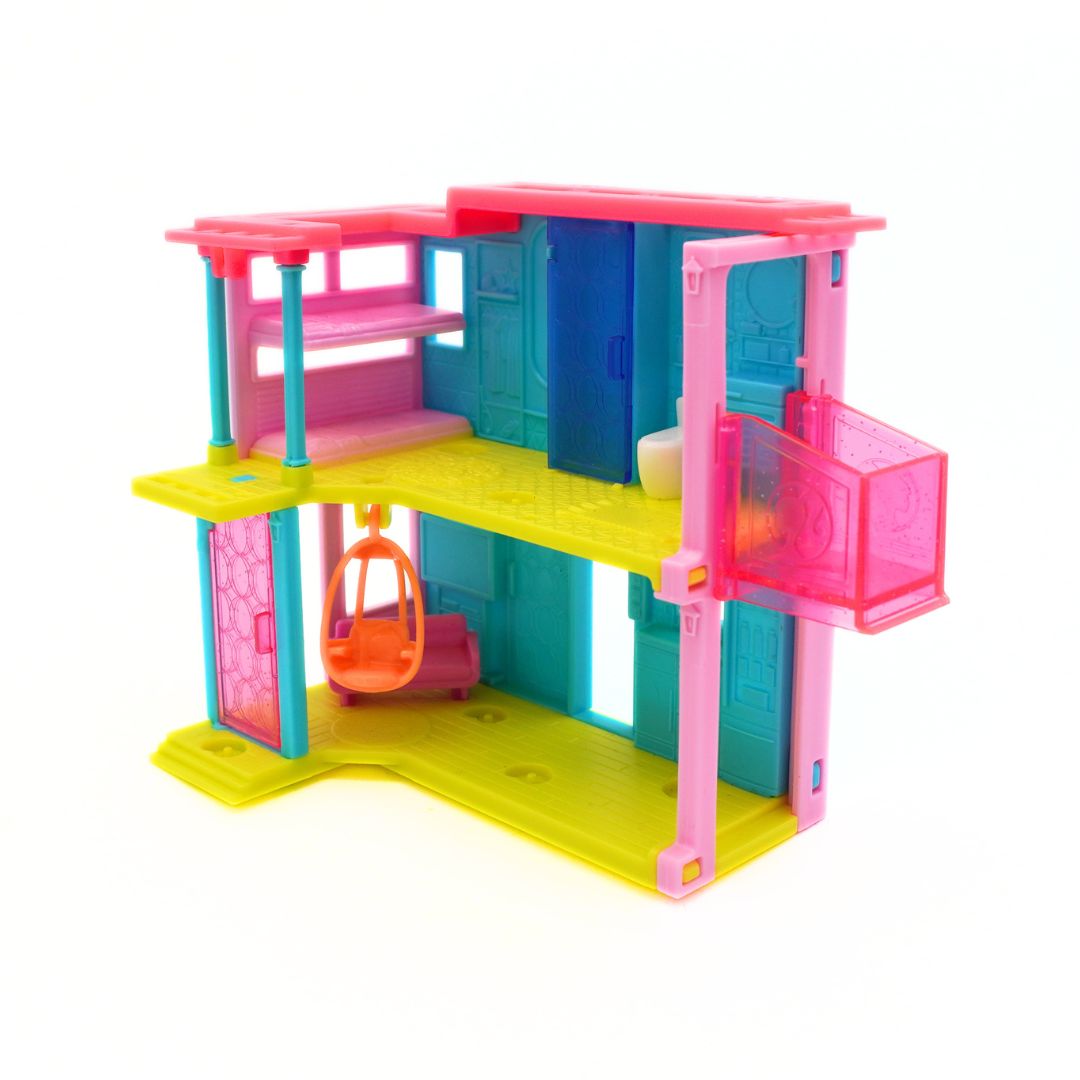 A colorful plastic toy house playset with a two-story design, featuring hot pink, bright yellow, teal blue, and orange details, isolated on a white background.