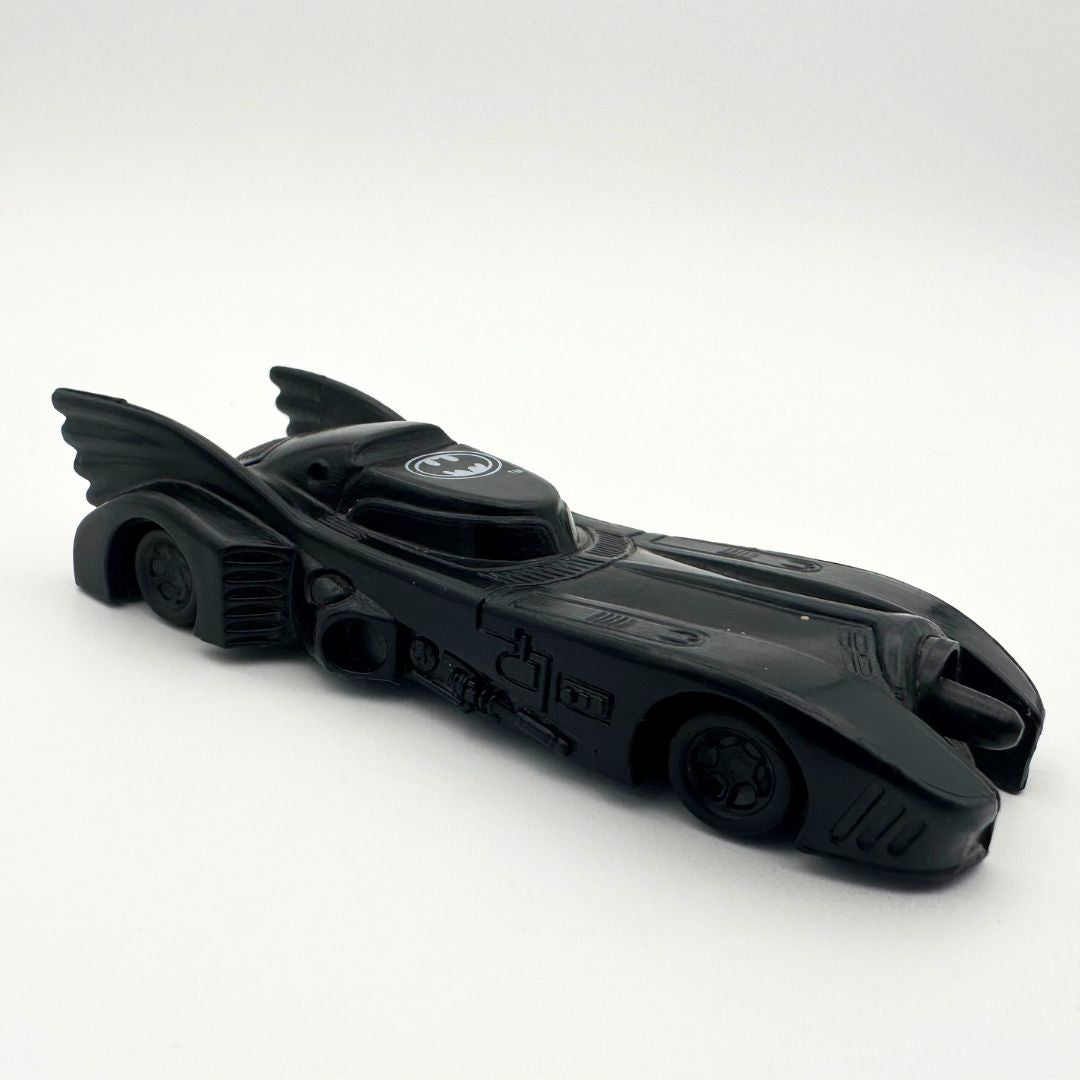 A photo of a vintage Batman batmobile toy