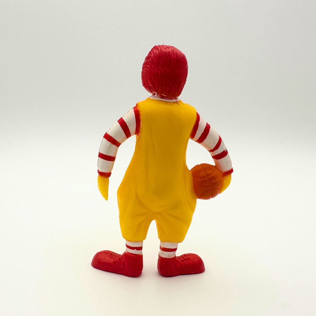 Back side of a vintage Ronald McDonald figure holding a basketball