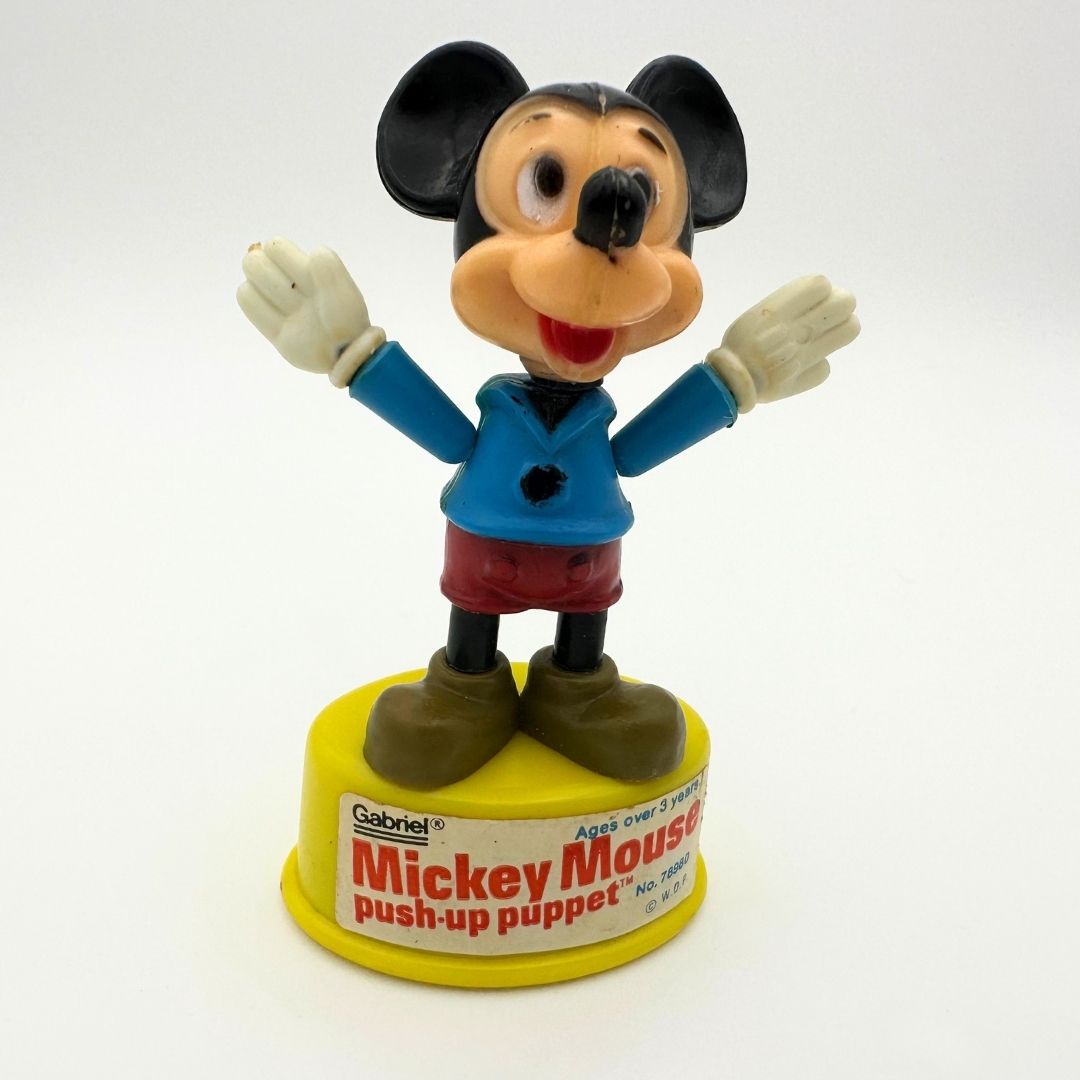 Vintage Mickey Mouse push-up puppet toy, wearing blue sweater and red shorts