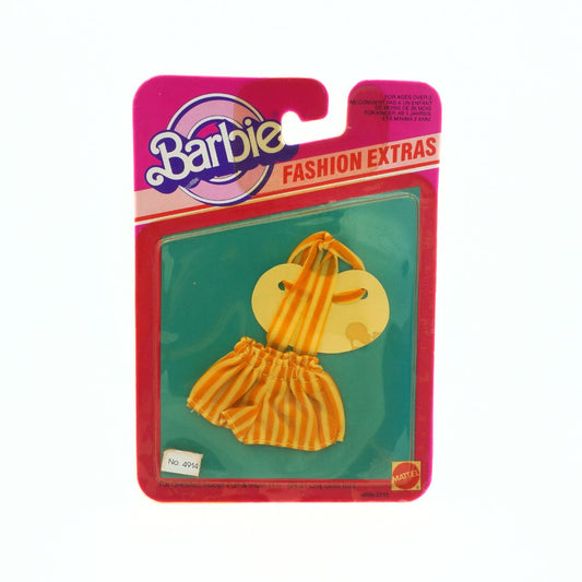 A front on photo of a vintage 1983 Barbie Fashion Extras showing a striped set of shorts