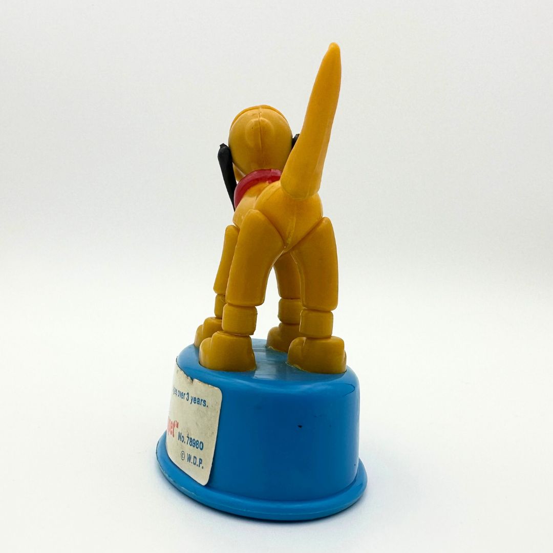 Photo of the back of the 70's Pluto push-up puppet Disney toy