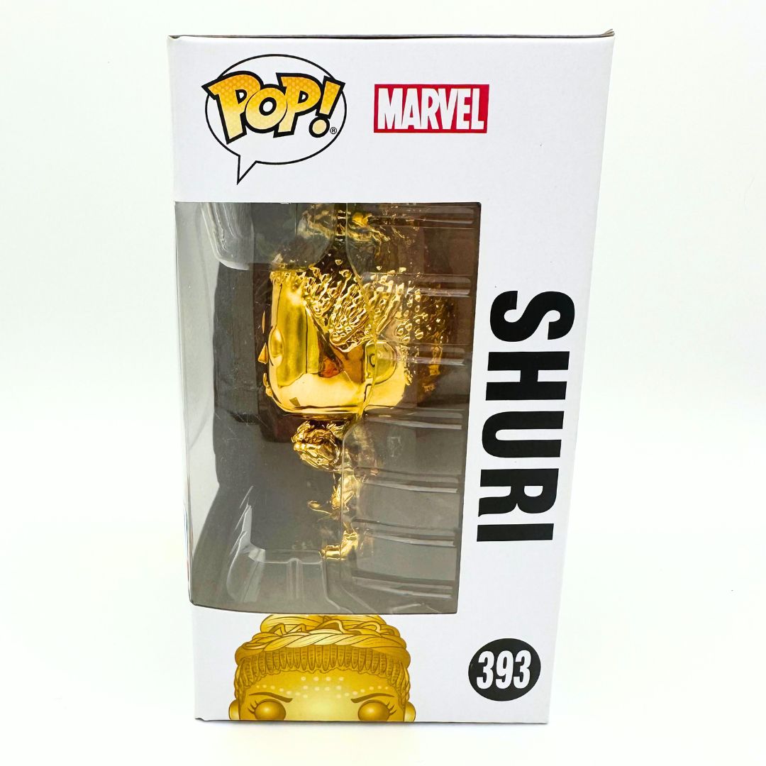 A side on photo of the Shuri 393 limited gold colourway Funko Pop in her box. 
