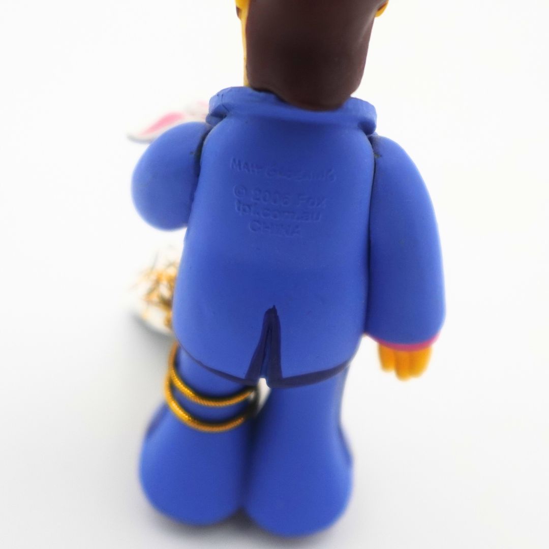 A close up of the copyright information of a young Homer Simpson figure