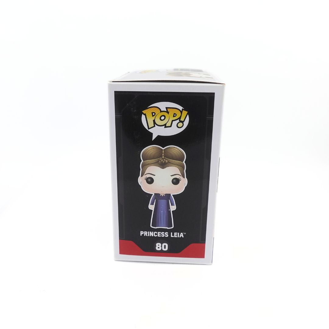 The side of the Funko Pop 80 Princess Leia Star Wars box, depicting the Pop! Logo, Princess Leia with a styled updo and dark purple dress