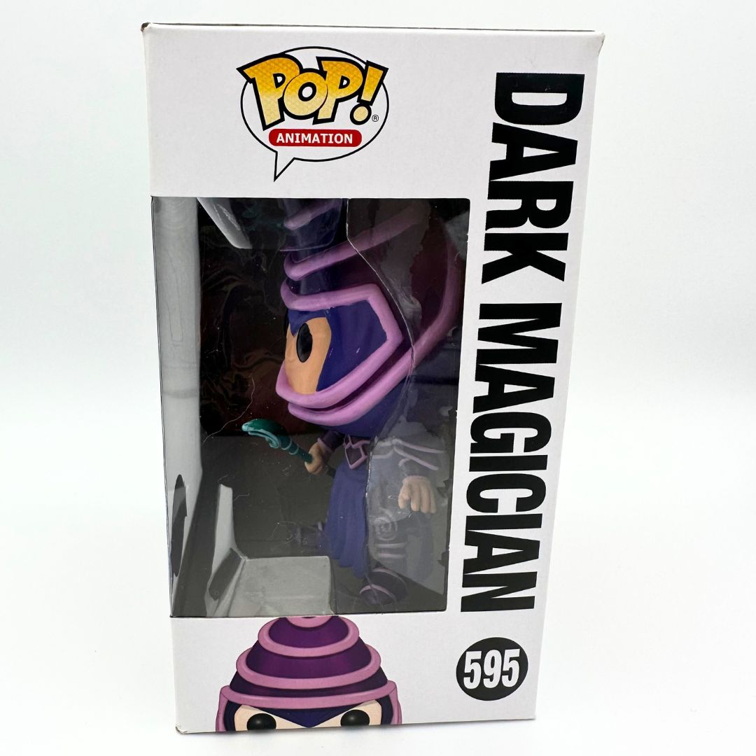 A side on photograph of the 595 Dark Magician Funko Pop box with the figure visible inside the packaging