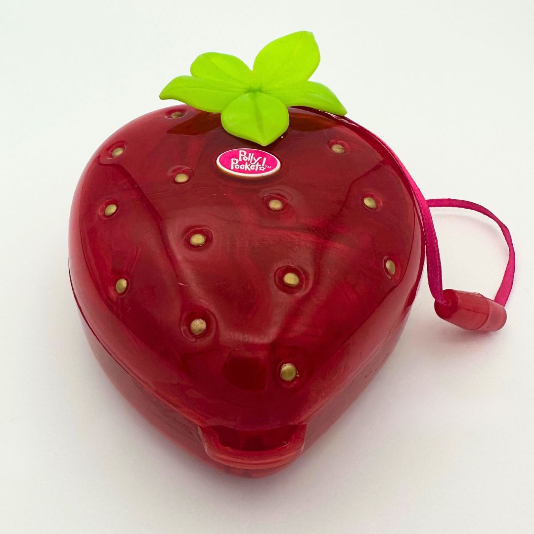 A front on photo of the Polly Pocket 90s Strawberry Fruit Surprise playset
