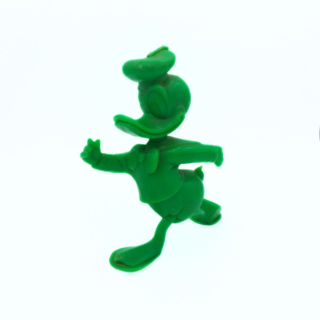 Green cartoon character figurine on a white background