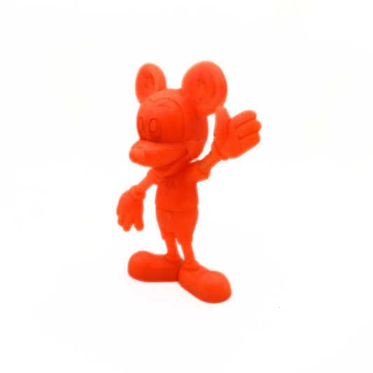 Orange cartoon character figurine on a white background