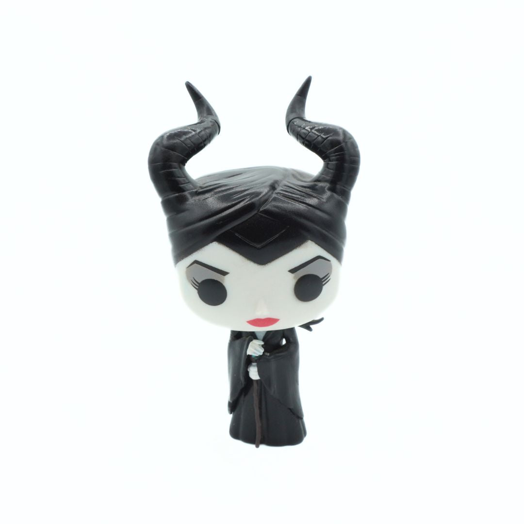 A stylized vinyl figure of Maleficent with black horns, a black dress, and a white face, shown against a plain white background.