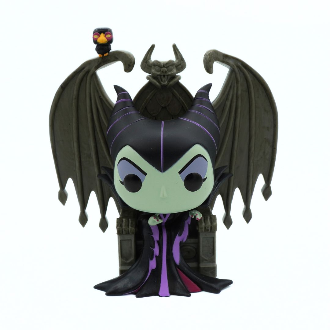 Villain character figurine with dark hair, green skin, and black wings on a white background