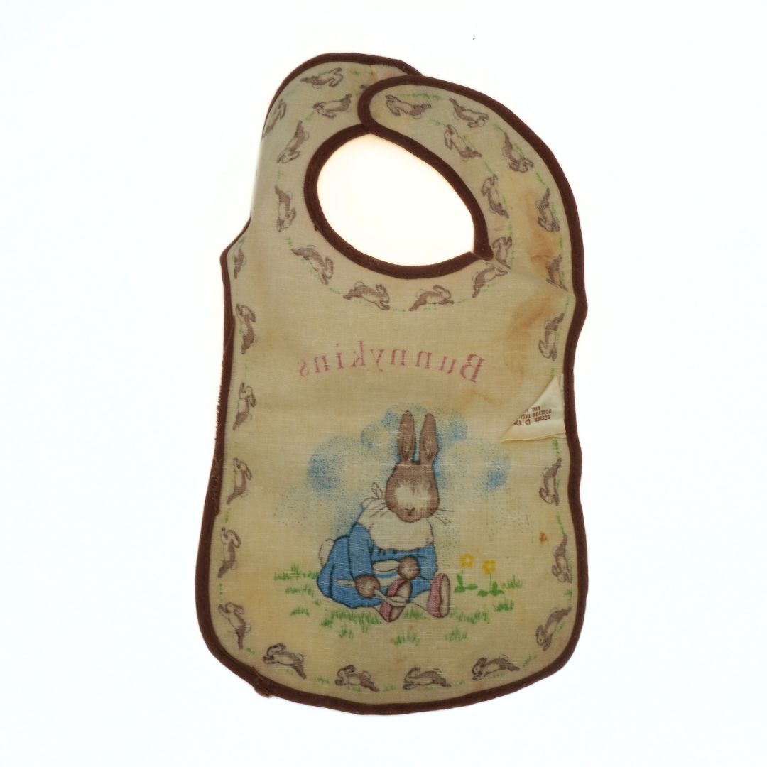 Baby bib with cartoon rabbit design on a white background