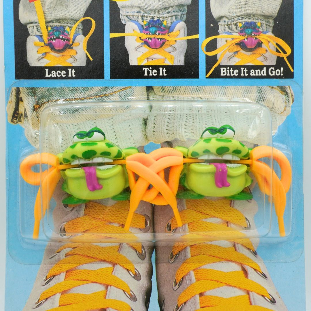 Packaged product with colorful shoelaces and a cartoon character on a blue background
