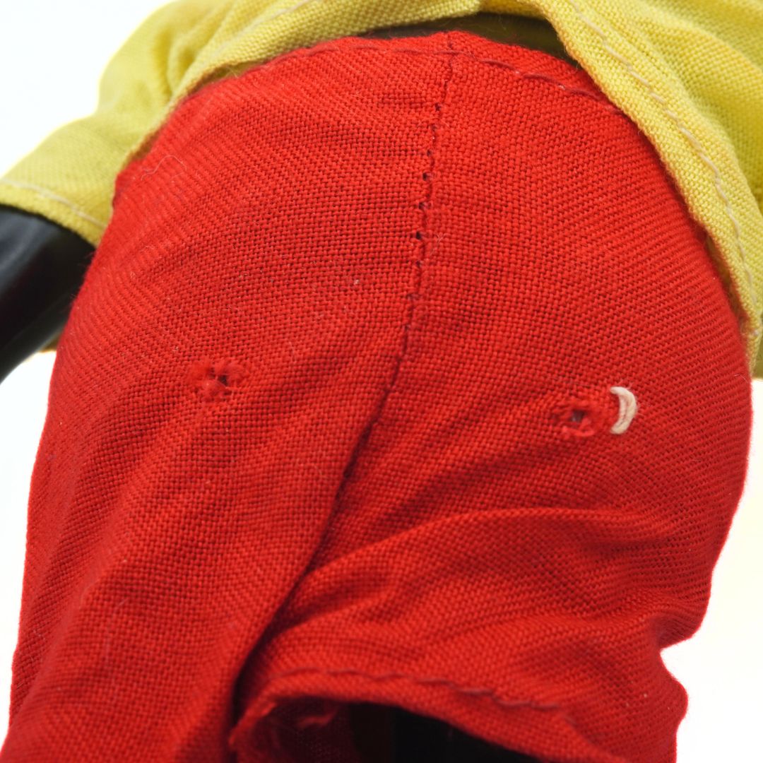 Close-up of a red fabric surface with visible texture and stitching.