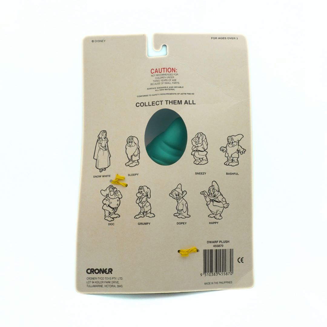 Package of a plush toy with character illustrations on a beige background