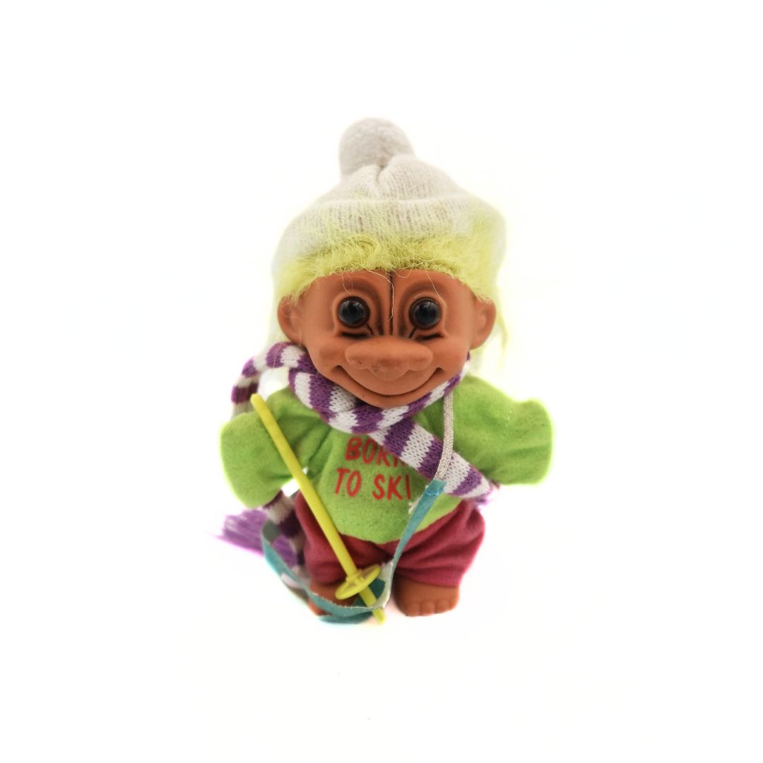 Born to Ski Troll doll with purple and white scarf, green shirt, red pants and yellow hair