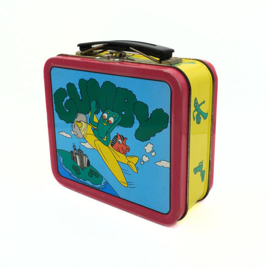 A vintage 1999 Gumby lunchbox with Gumby and Pokey riding a yellow airplane