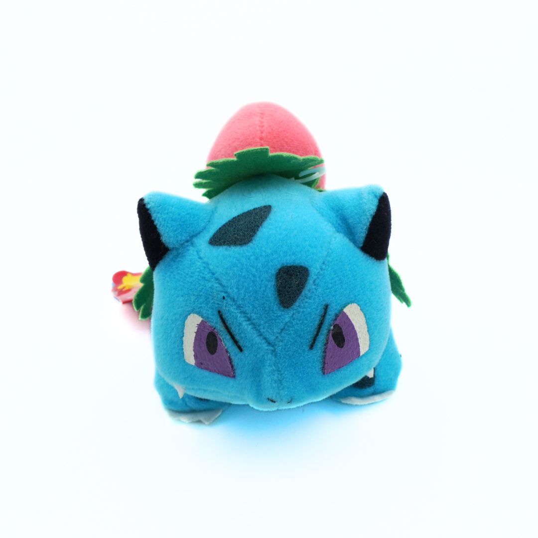 Blue plush toy with a pink top on a white background