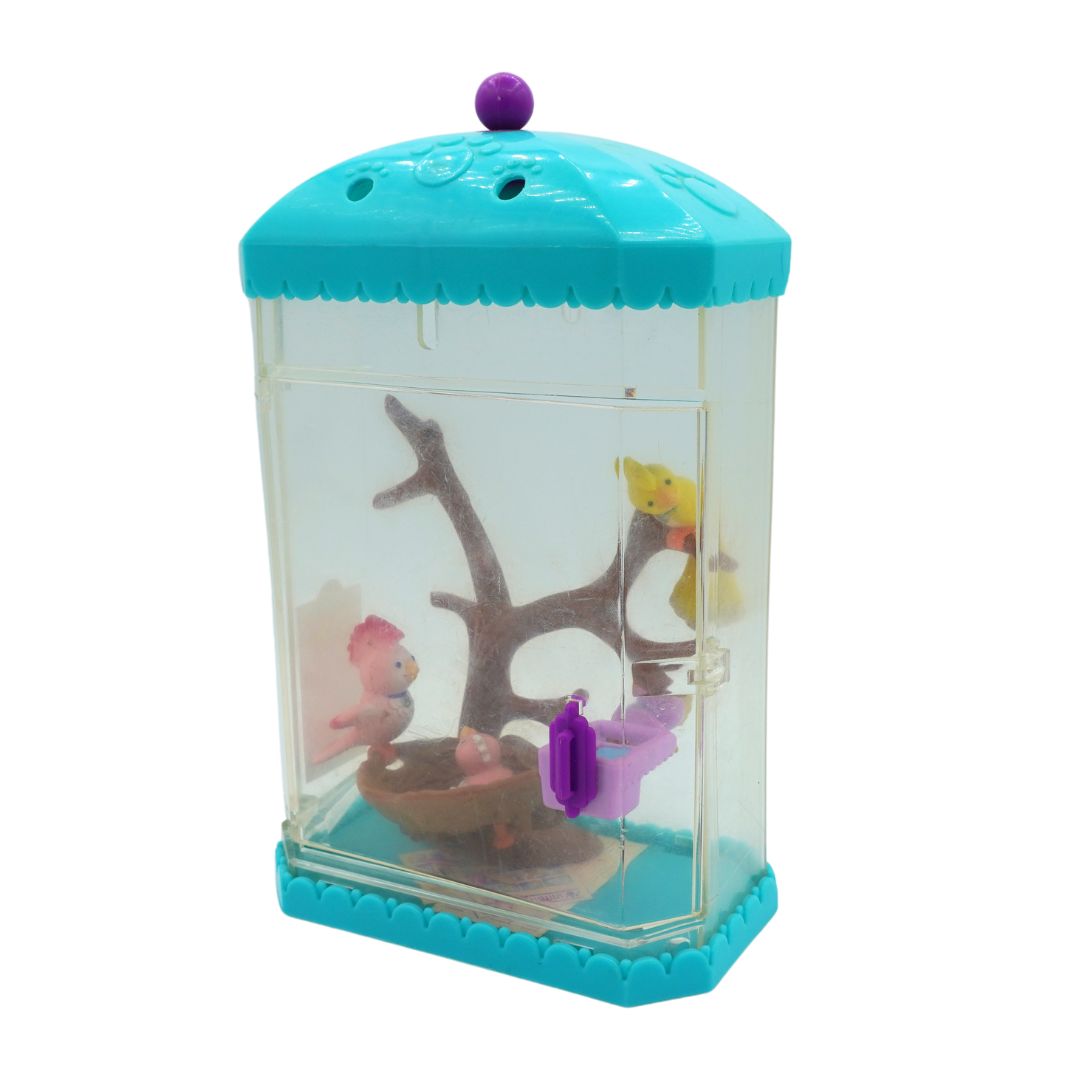 A blue 1994 Littlest Pet Shop bird display with brown tree details