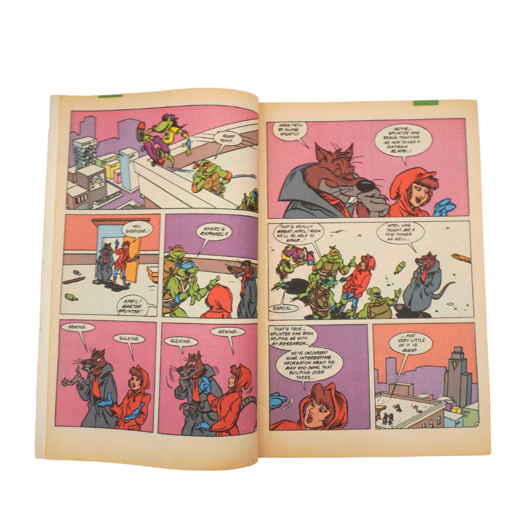 Open comic book with colorful panels on a white background