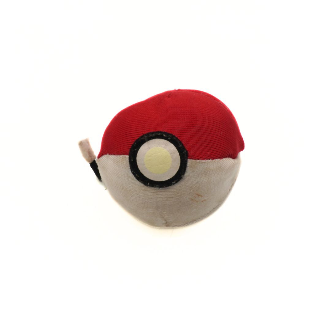 Plush toy resembling a Poké Ball on a white background