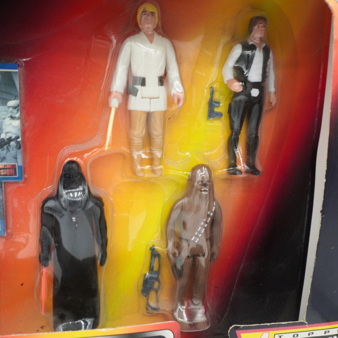 Four action figures in a vintage packaging with a red and yellow background.