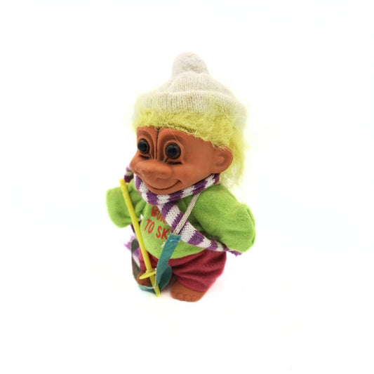 Vintage skiing Troll doll with green jumper, red banks, a white beany and yellow hair