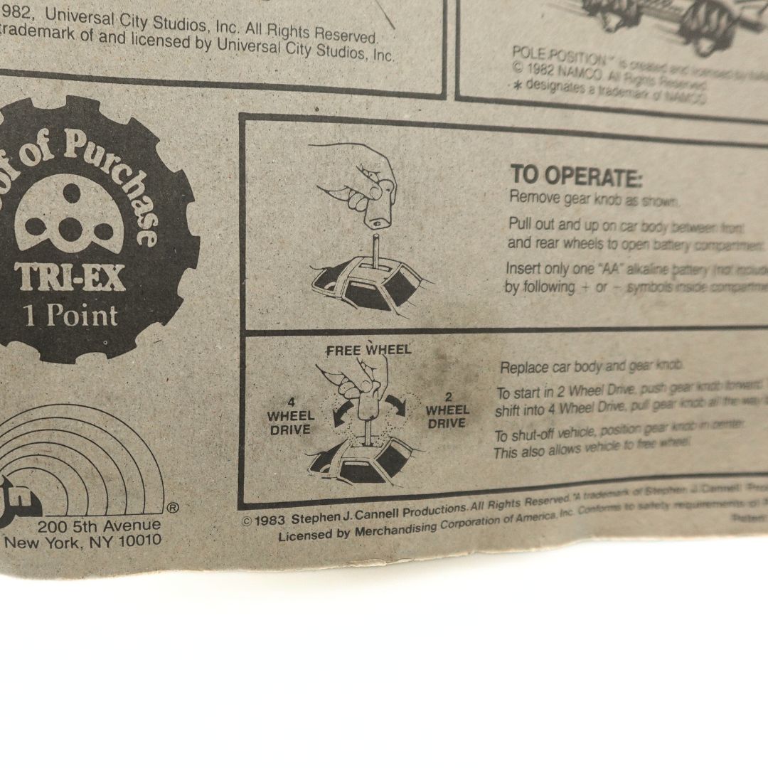 Close up of the cardback on an 1983 A Team toy car showing instruction on how to operate the toy