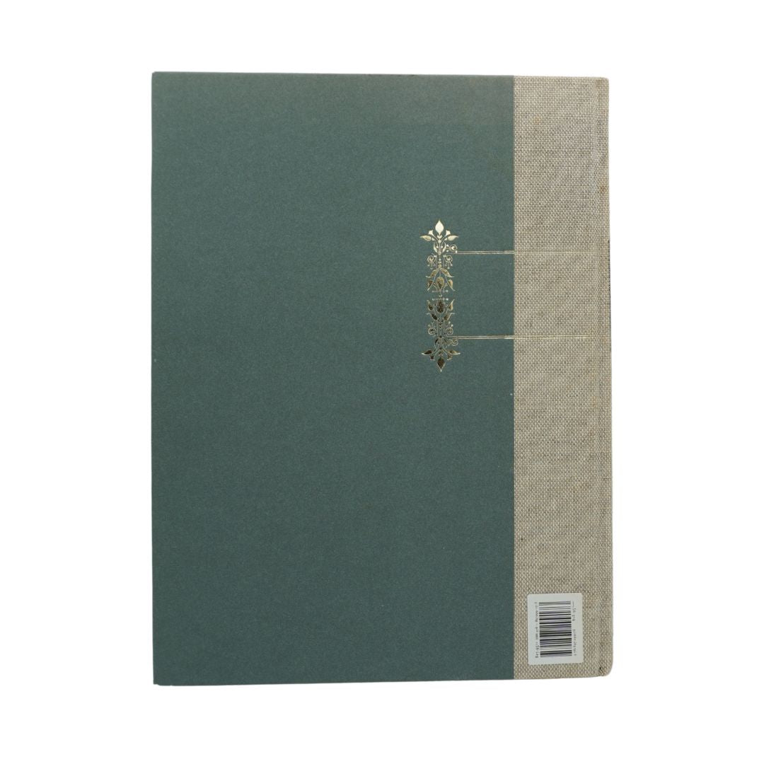 A hardcover book with a dark teal-green front cover, a natural beige linen-textured spine, and a small metallic gold decorative emblem in the center.