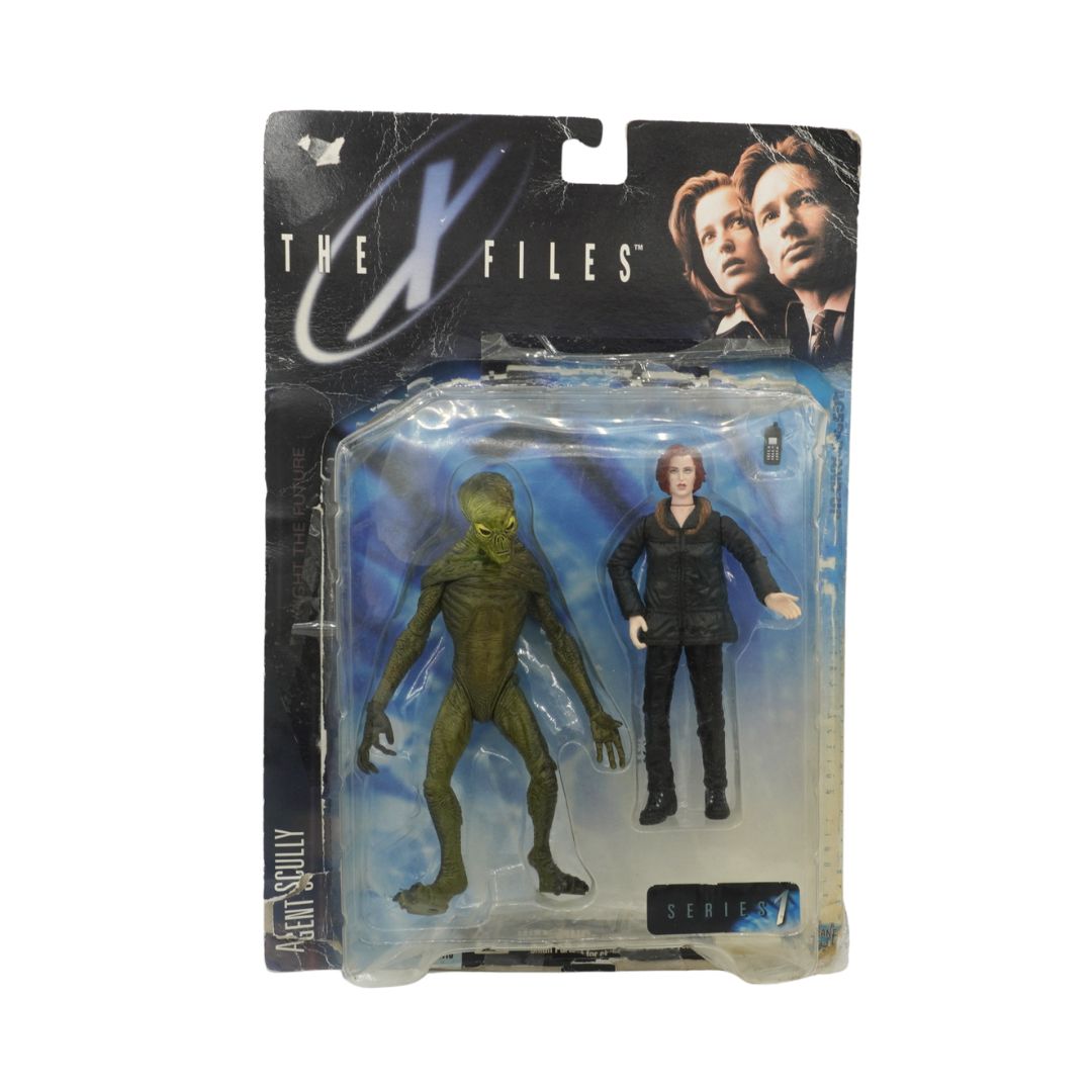 Action figure packaging featuring a green alien and a person, with 'The X-Files' branding.