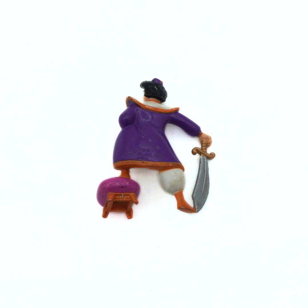 Aladdin figurine with purple robe and sword on a white background