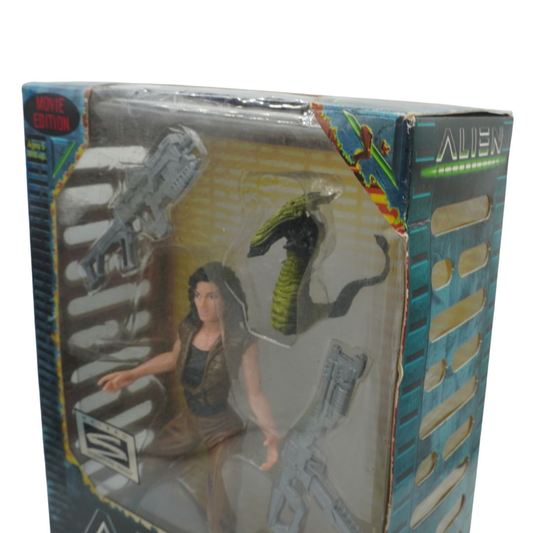 Toy figure packaging featuring a character and an alien creature, with 'Alien' branding.