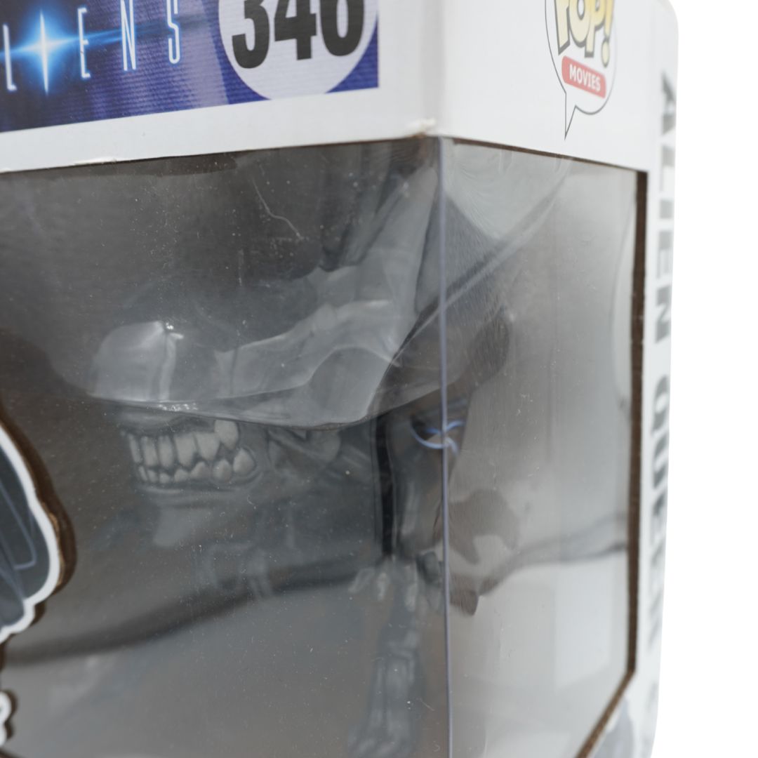 Alien Queen collectible figure in its original Funko Pop! Movies box packaging, showing the figure inside a clear plastic window box with Alien-themed graphics.
