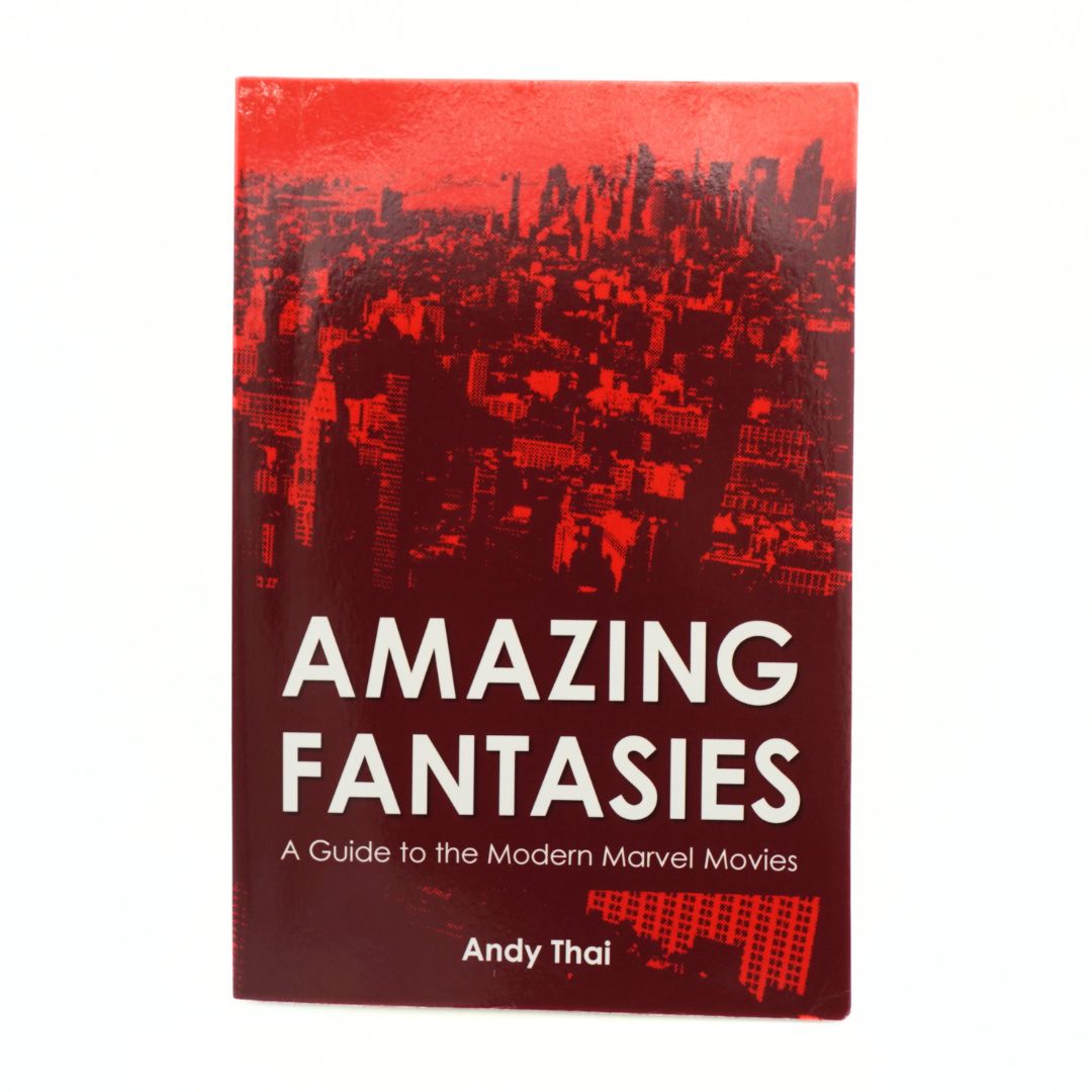 The book cover of 'Amazing Fantasies: A Guide to the Modern Marvel Movies' by Andy Thai, featuring a dark red and black cityscape graphic with bold white text, shown on a plain white background.