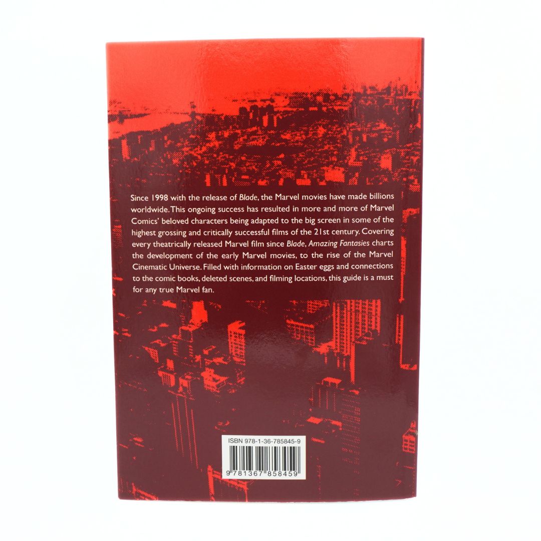 The back cover of a Marvel guide book featuring a red and black cityscape illustration and white text detailing Marvel movie adaptations since 1996, with a barcode at the bottom.