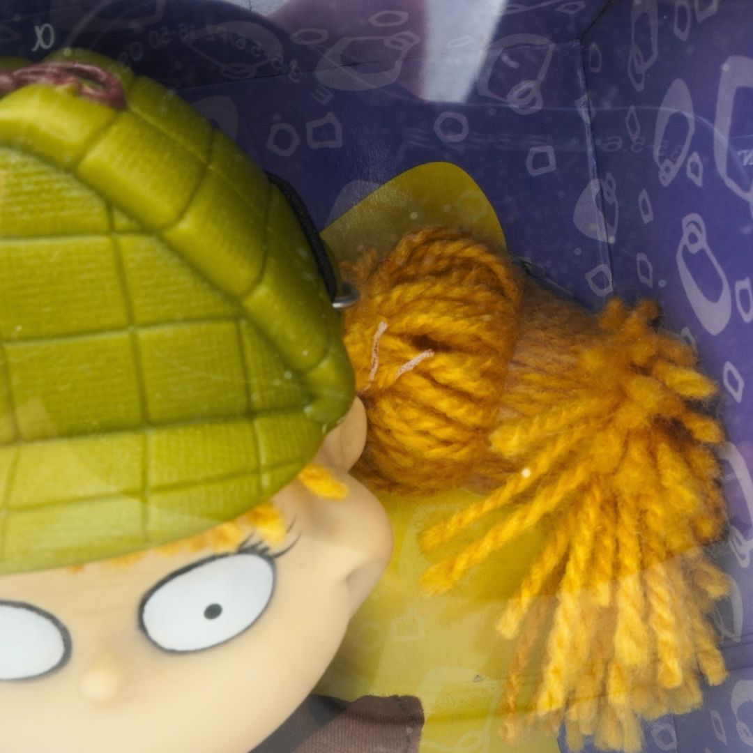 Closeup of a 90s Rugrats Angelica doll showing the burst elastic