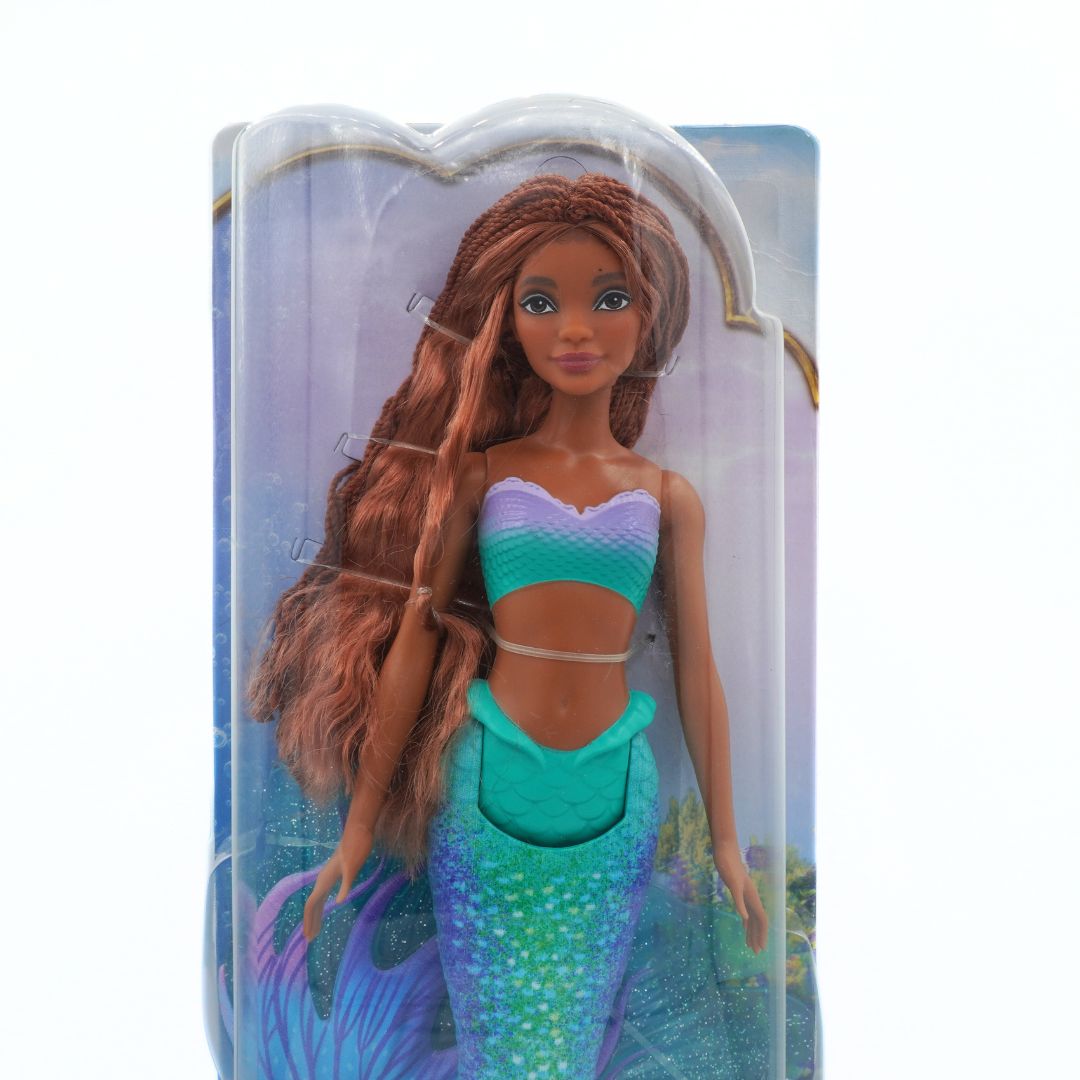 Mermaid doll in packaging with a blue and purple tail.