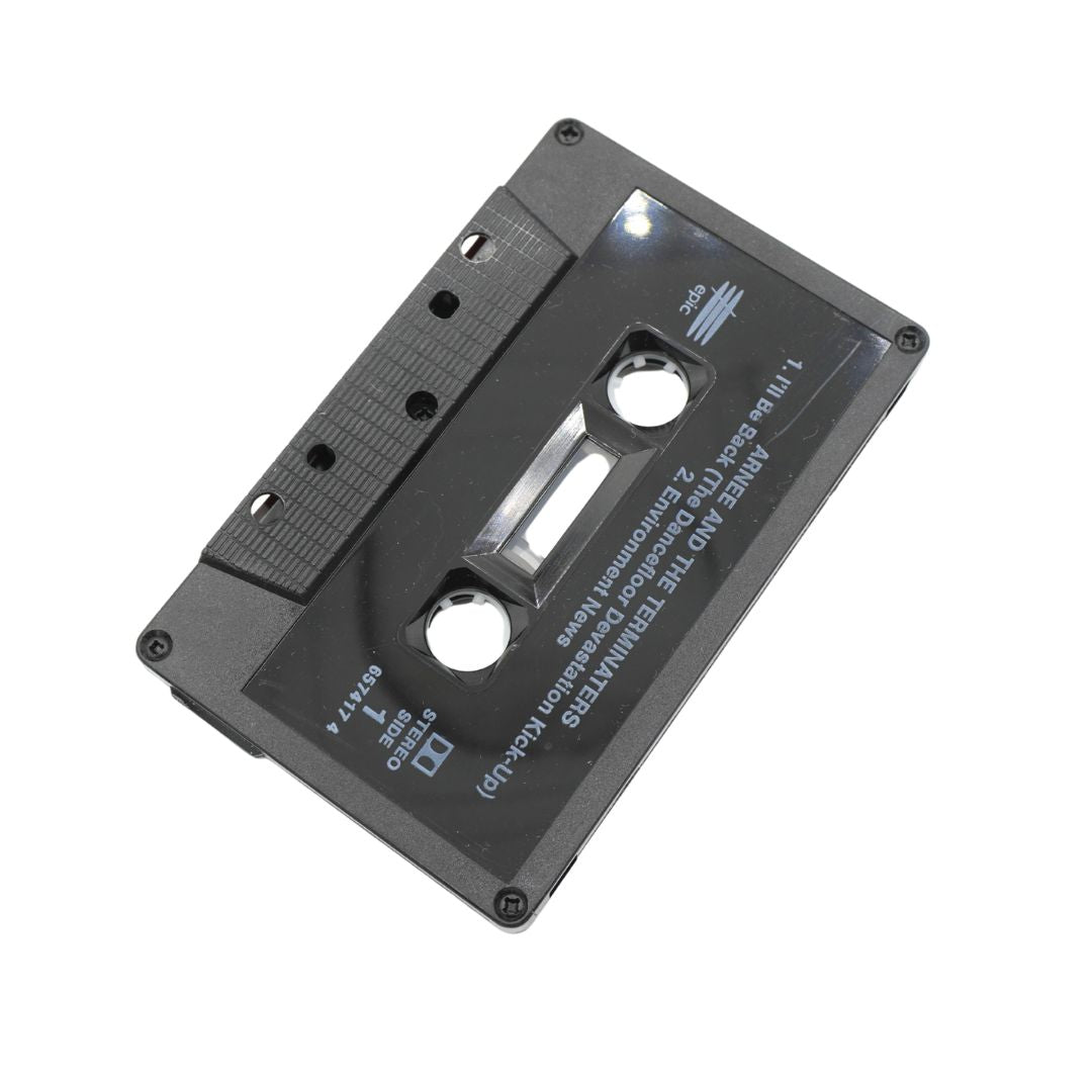 A black plastic cassette tape with white printed text, shown at an angle on a plain white background.