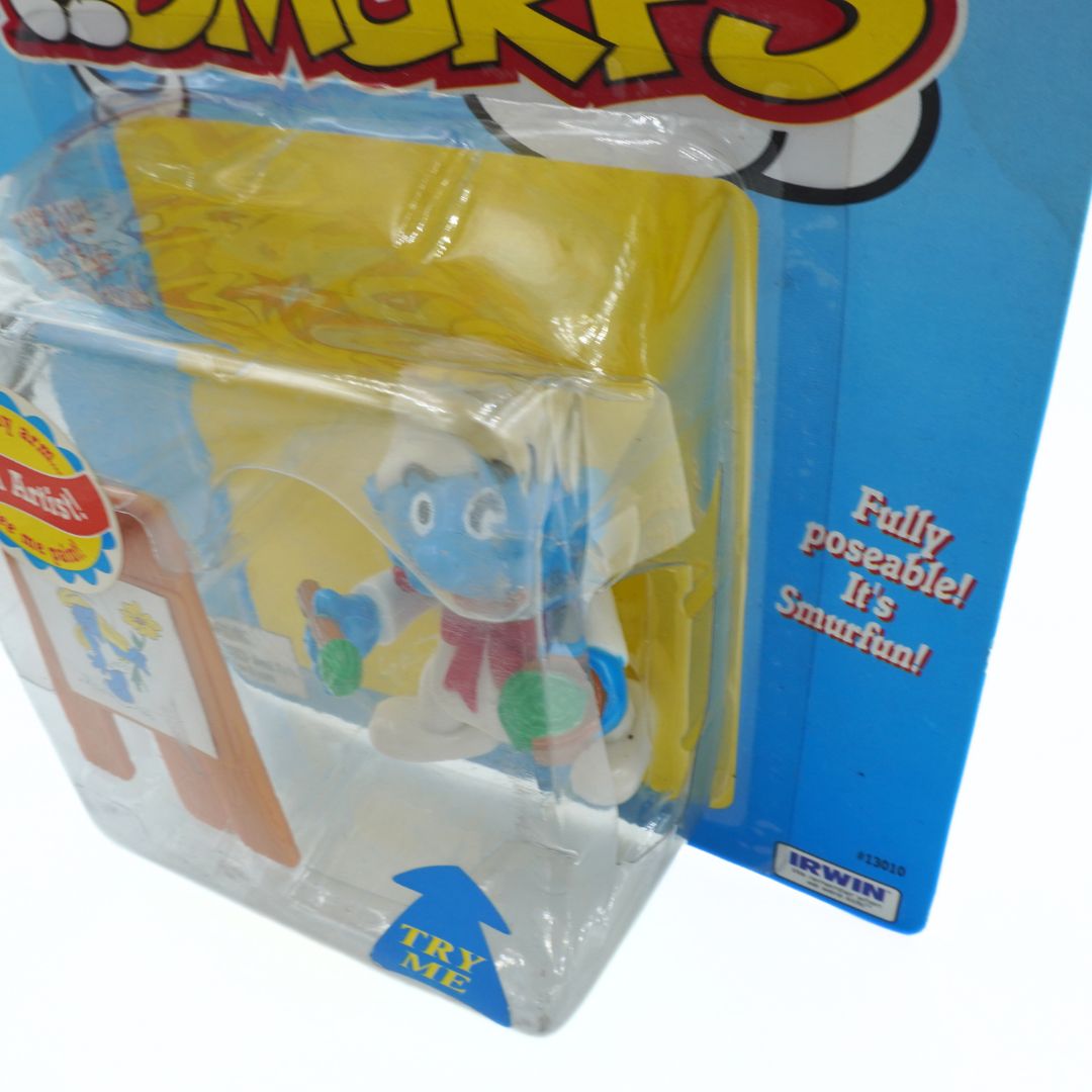 Toy figure in packaging with 'Smurfs' branding on a blue background