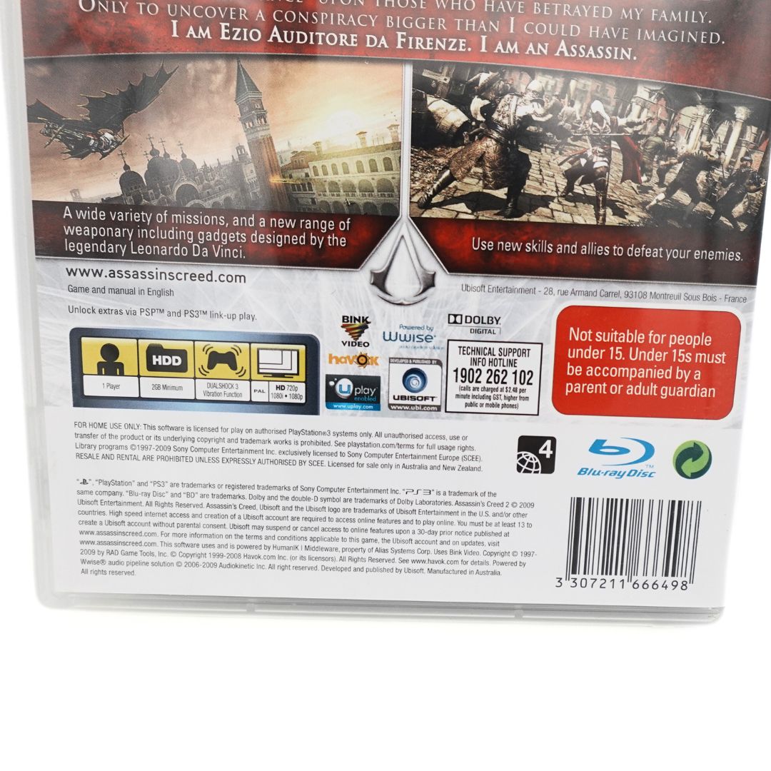 Closeup of the barcode and branding information on the case for the PS3 game Assassins Creed II