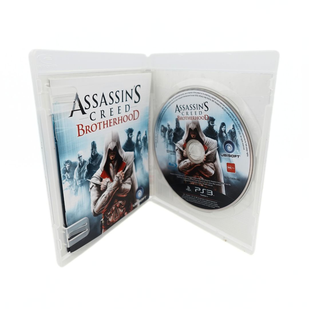 Inside cover of the Assassins Creed Brotherhood showing the pamphlet and disc