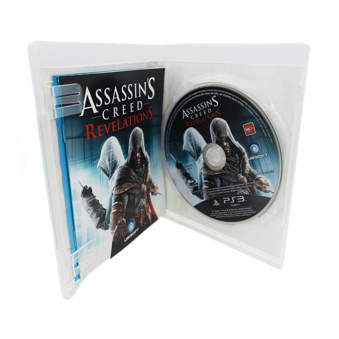 Inside case of the Assassins Creed Revelations game showing the case, disc and pamphlets