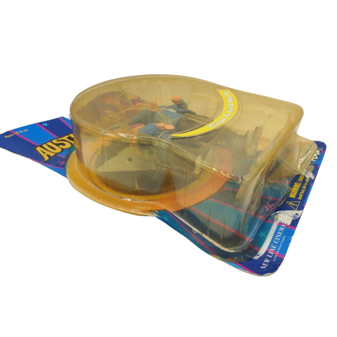 Toy figure in a clear plastic packaging on a blue and yellow background
