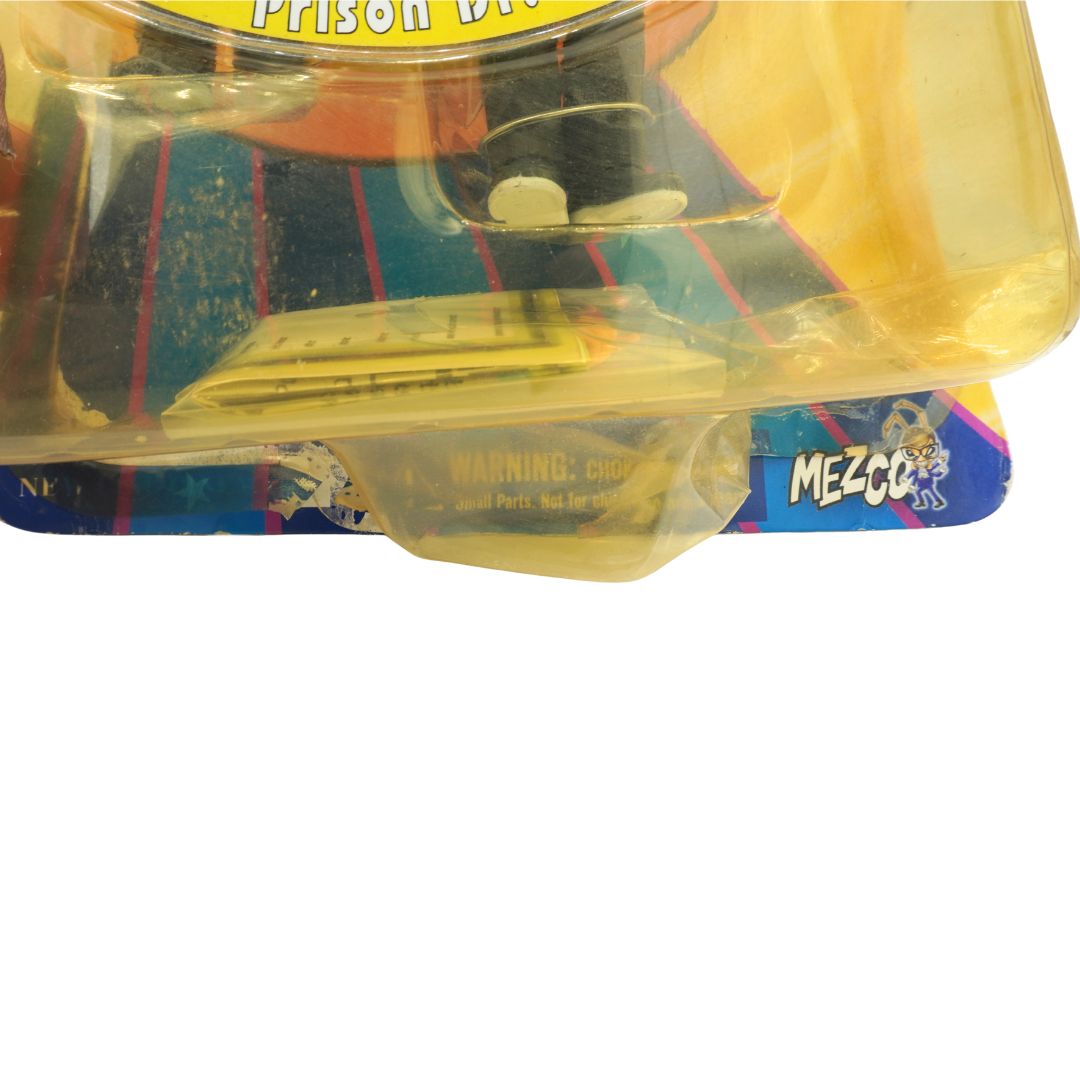 Toy figure in packaging with Mezco logo on a white background