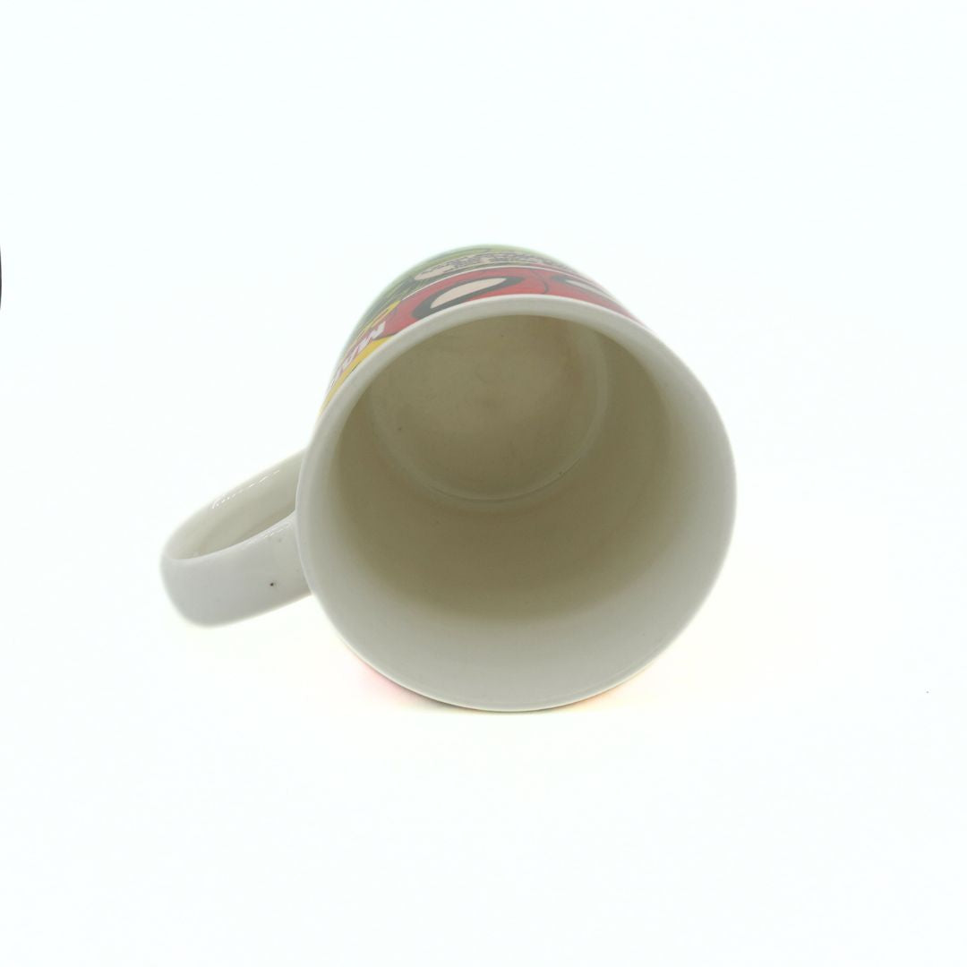 White ceramic mug with colorful design on a white background