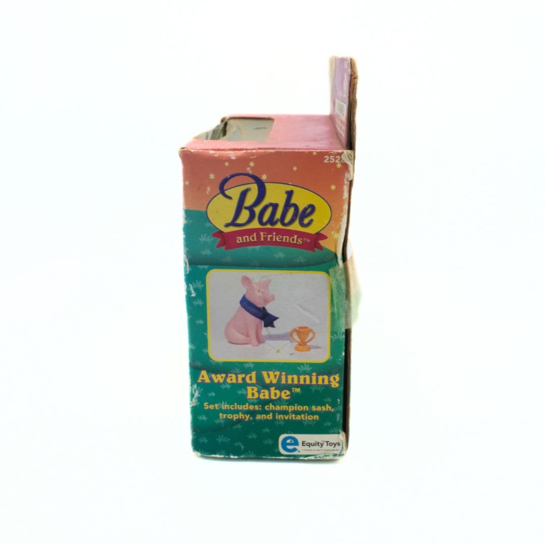 Vintage 'Babe and Friends' toy box with a pink top and green bottom on a white background.