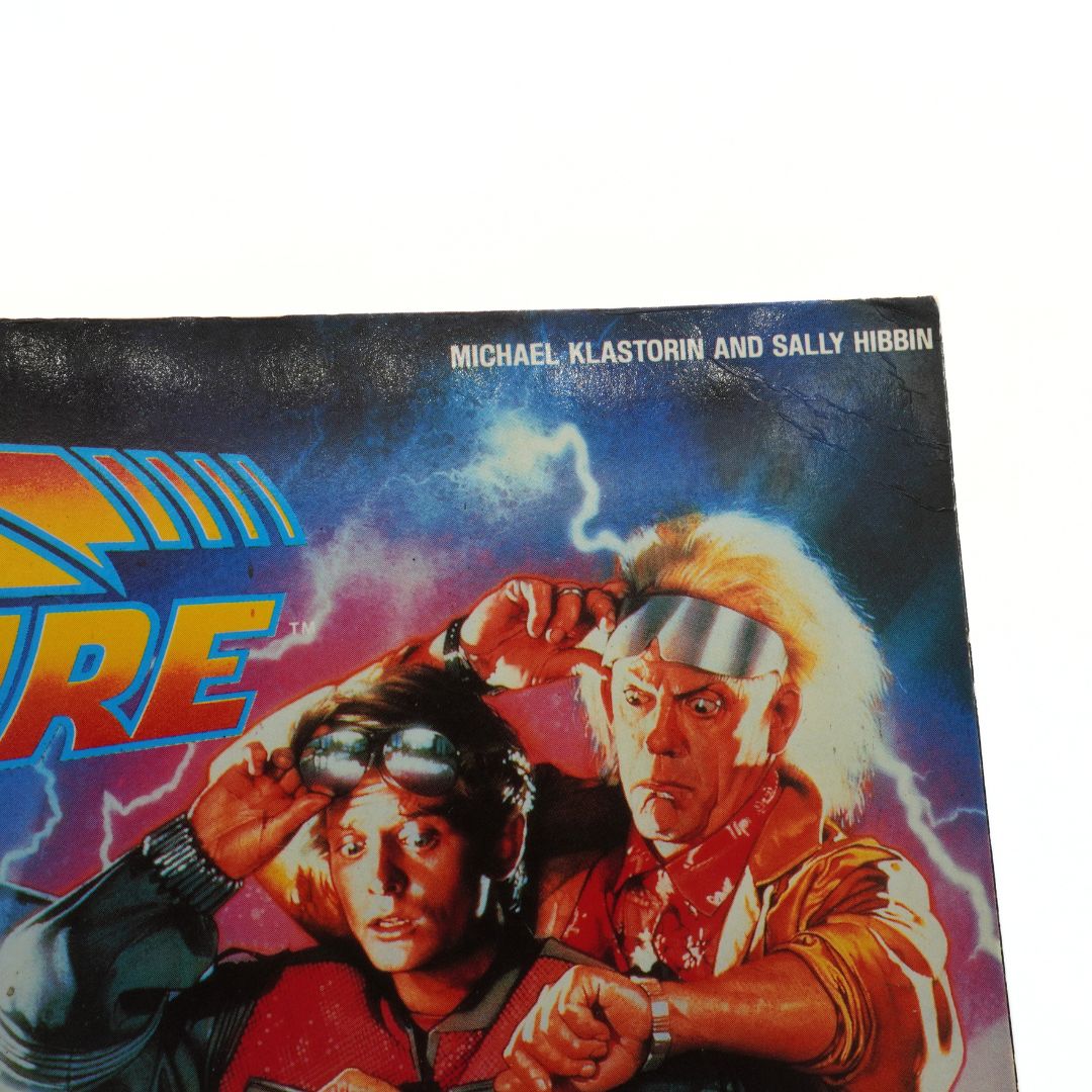 Book cover with two characters and text on a white background