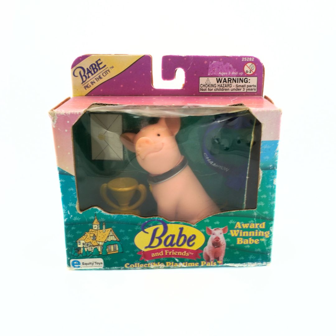 Packaged toy pig with 'Babe and Friends' branding on a white background