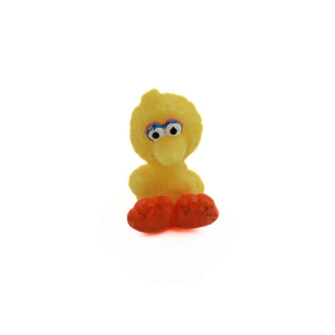 A mini baby Big Bird figurine, sitting down